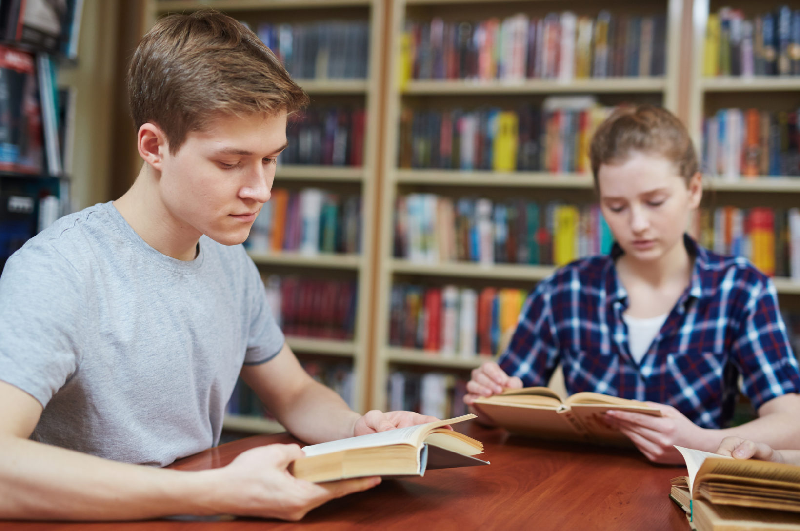 Middle school students reading together while building learning skills and academic confidence